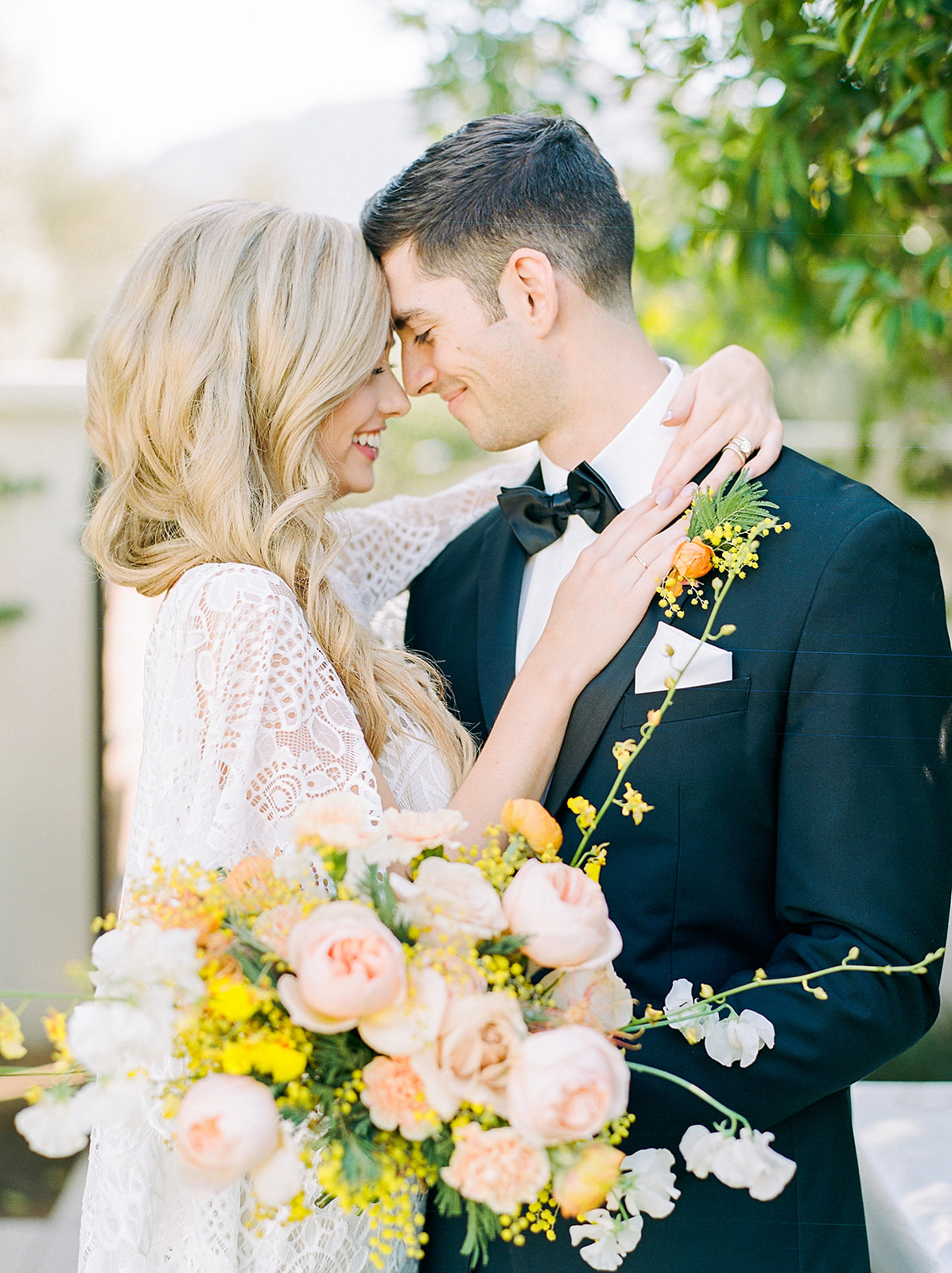 boho bride and groom with orange and yellow colorful flowers